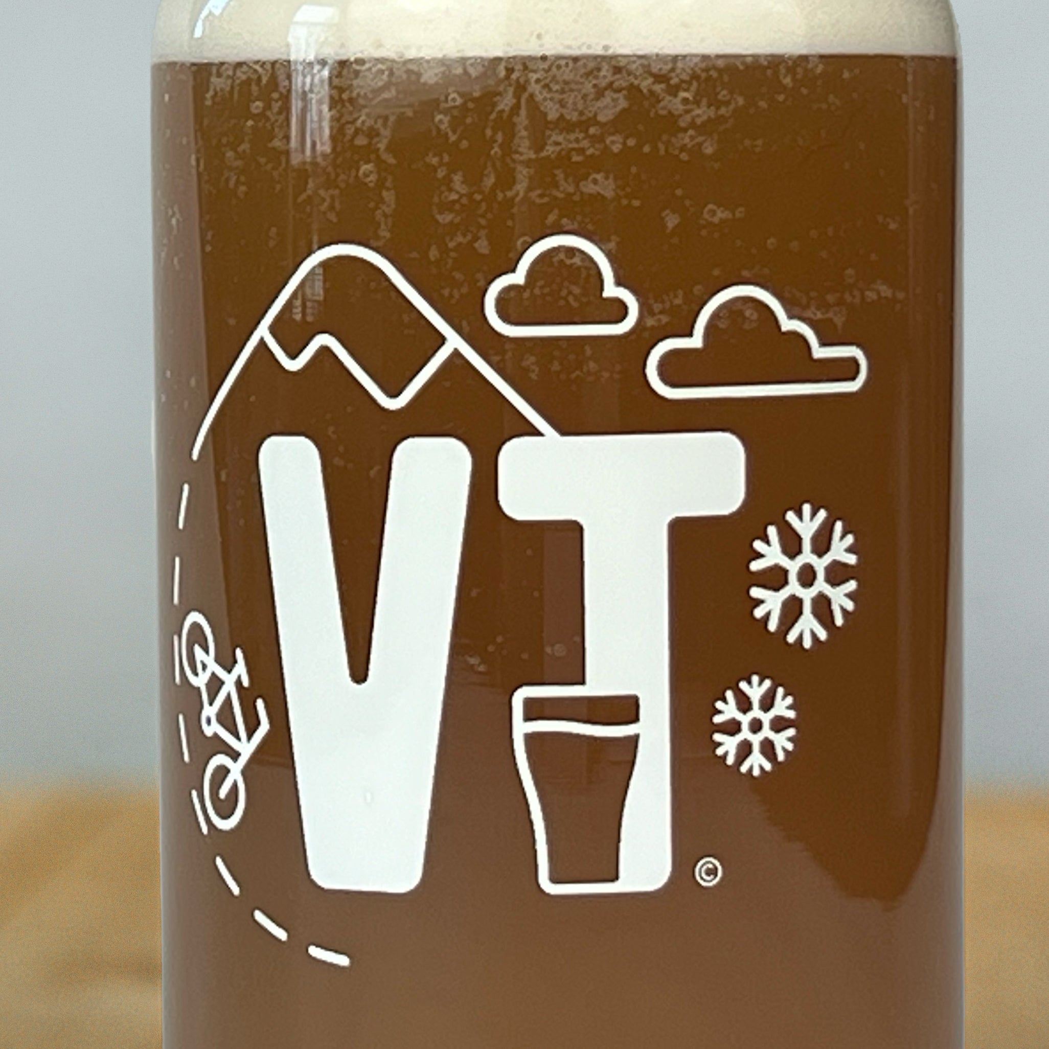 Close up of Vermont Eclectic Company beer can pint glasses with beer